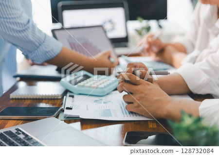Financial business team in office, financial expert analyze business report graph and finance chart at corporate office. Concept of finance economy, banking business and stock market research. Financial business team in office, financial expert analyze business report graph and finance chart at corporate office. Concept of finance economy, banking business and stock market research. 128732084