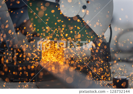 Worker cutting steel pipe in construction site. 128732144