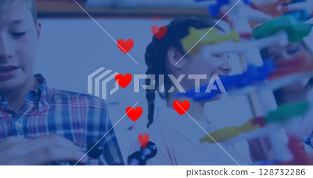 Plaid-shirted boy and braided girl assembling plastic model in science lab, with colorful rods 128732286