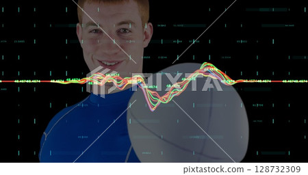 Spinning male athlete wearing blue sports shirt and leggings in studio, with basketball and data Spinning male athlete wearing blue sports shirt and leggings in studio, with basketball and data 128732309