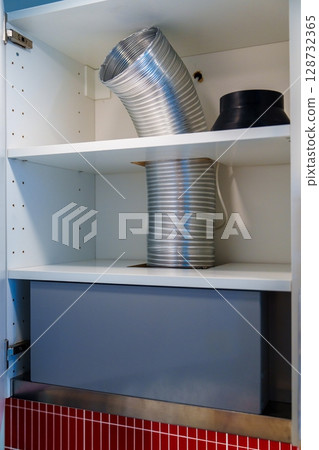 Kitchen Ventilation System Installation Inside Cabinet with Shelves and Ductwork Kitchen Ventilation System Installation Inside Cabinet with Shelves and Ductwork 128732365