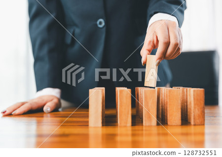 Business risk control concept, Businesswoman protect wooden block fall to planning and strategy in risk to business alternative and prevent. investment insurance business. Business risk control concept, Businesswoman protect wooden block fall to planning and strategy in risk to business alternative and prevent. investment insurance business. 128732551