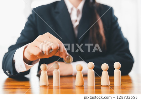 Hands protecting family wooden model for insurance and assurance life concept. Businessman hand gesture protecting wooden domino falling to family dolls for insurance and assurance. Hands protecting family wooden model for insurance and assurance life concept. Businessman hand gesture protecting wooden domino falling to family dolls for insurance and assurance. 128732553