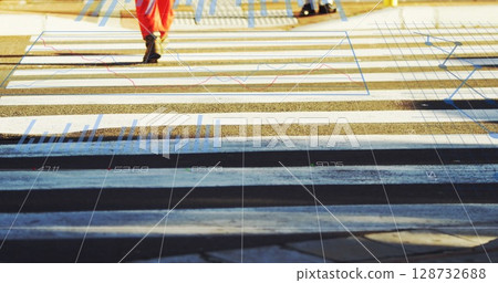 Walking adult in red pants and boots crossing urban street at zebra crosswalk, with data overlays 128732688