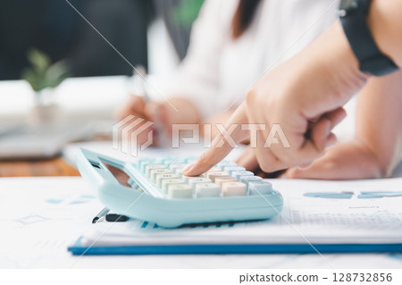 Financial business team in office, financial expert analyze business report graph and finance chart at corporate office. Concept of finance economy, banking business and stock market research. Financial business team in office, financial expert analyze business report graph and finance chart at corporate office. Concept of finance economy, banking business and stock market research. 128732856