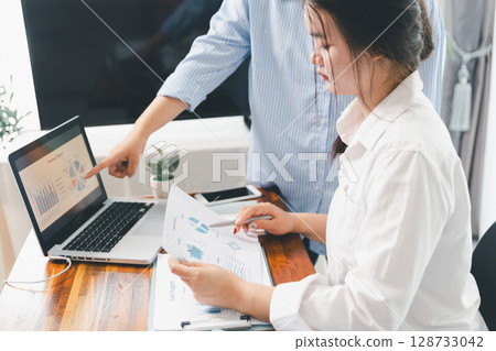 Teamwork with business people analysis cost graph on desk at meeting room. partnership analysis graph company financial budget report, cost work progress planning, business team analysis graph data 128733042