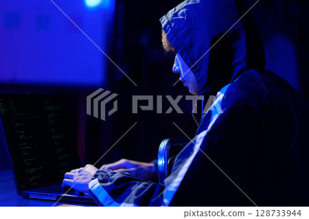 Hacker cyberattack representing data breach and cybersecurity threat in digital system 128733944