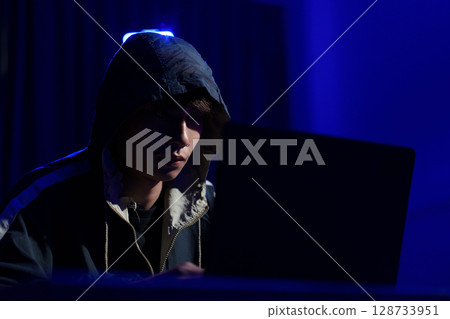 Hacker cyberattack representing data breach and cybersecurity threat in digital system 128733951