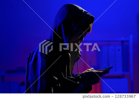 Hacker using smartphone for phishing attack and data theft in dark cyber environment Hacker using smartphone for phishing attack and data theft in dark cyber environment 128733967