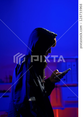 Hacker using smartphone for phishing attack and data theft in dark cyber environment Hacker using smartphone for phishing attack and data theft in dark cyber environment 128733968