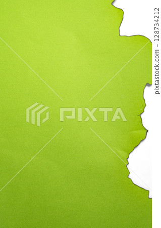 Green paper ripped message torn with burnt edges isolated on a white background. Copy space 128734212
