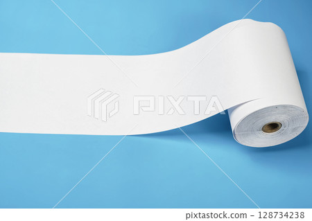 Roll of thermal paper for a receipt on a blue background. Copy space Roll of thermal paper for a receipt on a blue background. Copy space 128734238