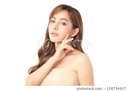 A beautiful young Asian woman with clean, fresh skin against a white background. Skincare, facial treatment, cosmetology, beauty, and spa. An elegant portrait of an Asian woman. A beautiful young Asian woman with clean, fresh skin against a white background. Skincare, facial treatment, cosmetology, beauty, and spa. An elegant portrait of an Asian woman. 128734427