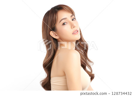 A beautiful young Asian woman with clean, fresh skin against a white background. Skincare, facial treatment, cosmetology, beauty, and spa. An elegant portrait of an Asian woman. 128734432