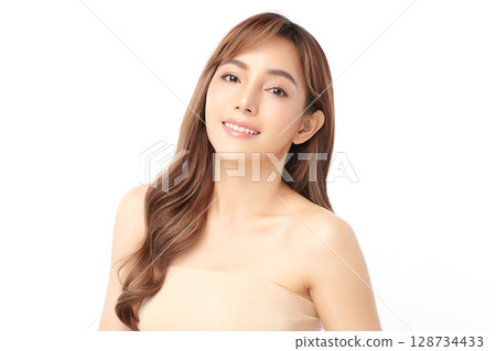 A beautiful young Asian woman with clean, fresh skin against a white background. Skincare, facial treatment, cosmetology, beauty, and spa. An elegant portrait of an Asian woman. 128734433