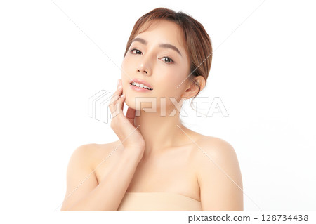 A beautiful young Asian woman with clean, fresh skin against a white background. Skincare, facial treatment, cosmetology, beauty, and spa. An elegant portrait of an Asian woman. 128734438