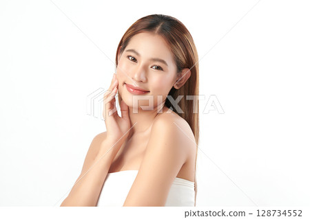 A beautiful young Asian woman with clean, fresh skin against a white background. Skincare, facial treatment, cosmetology, beauty, and spa. An elegant portrait of an Asian woman. A beautiful young Asian woman with clean, fresh skin against a white background. Skincare, facial treatment, cosmetology, beauty, and spa. An elegant portrait of an Asian woman. 128734552