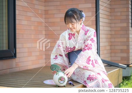 A woman setting up mosquito coils 128735225