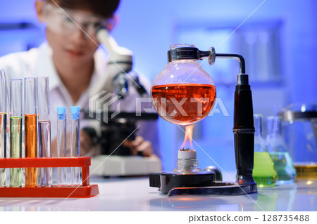Chemical experiment with heated flask in laboratory 128735488