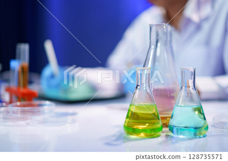Chemical solutions in glassware during lab experiment Chemical solutions in glassware during lab experiment 128735571