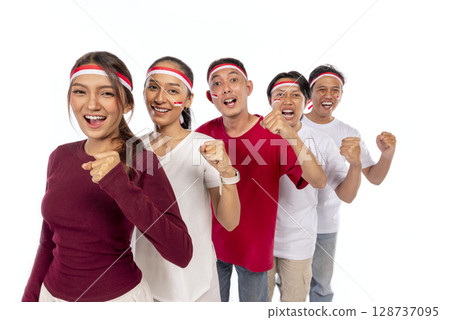 Indonesian southeast asian people celebrating Indonesia Independence Day on the 17th of August with an excited expression isolated over a white background. Concept of Kemerdekaan Indonesia 128737095