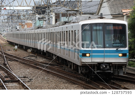 Metro Tozai Line 05 series non-updated train entering Mitaka Station Metro Tozai Line 05 series non-updated train entering Mitaka Station 128737593