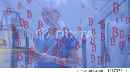 Image of bitcoins sings failing over caucasian female doctor 128737844