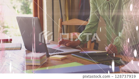 Image of screens of network of connections against mid section of woman using laptop 128737919