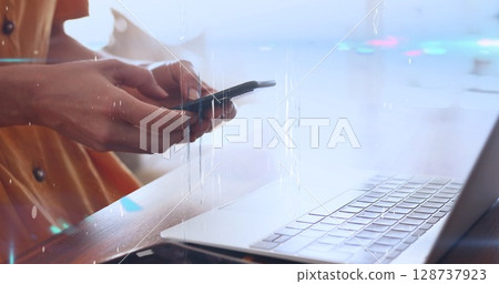 Image of screens of network of connections over mid section of woman using laptop and smartphone 128737923