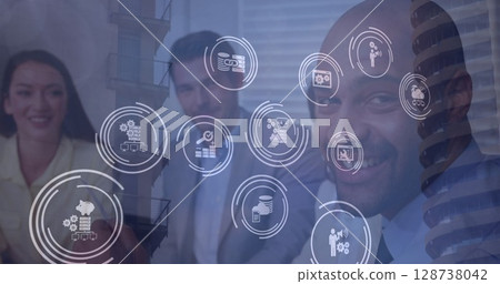 Multiple digital icons over diverse businesspeople exchanging cards and discussing at office 128738042