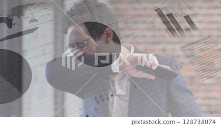 Statistical data processing against caucasian businessman covering his face while sneezing at office 128738074
