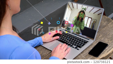 Image of media icons over caucasian woman having image call with colleague Image of media icons over caucasian woman having image call with colleague 128738121