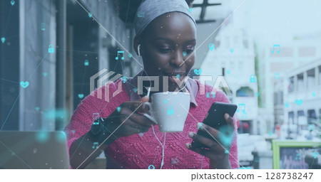 Image of network of connections with social media icons over caucasian woman using laptop 128738247