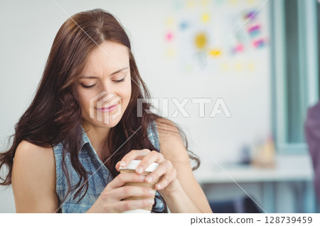 Opening small jar, woman focusing at desk in bright office space with sticky notes, copy space 128739459
