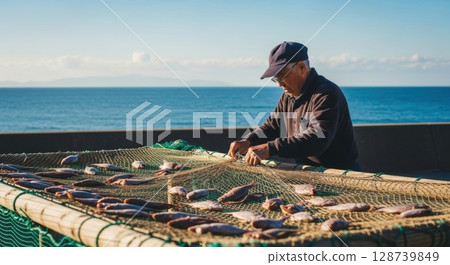 Realistic photos of fishermen drying local seafood 128739849