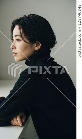 Portrait of a sophisticated woman in a black turtleneck 128740848