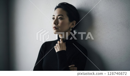 Profile of a black turtleneck woman leaning against a wall and thinking 128740872