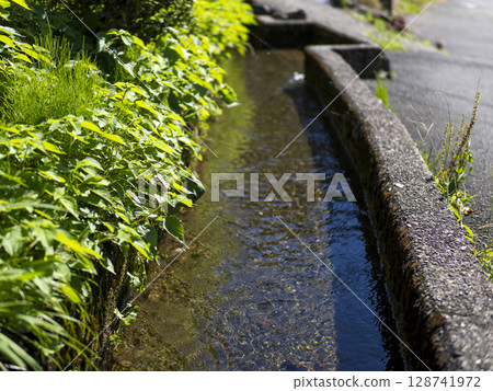 The irrigation channel that runs through Kayabuki Village, Miyama 128741972