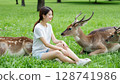 Female tourist and deer 128741986