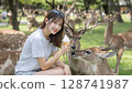 Female tourist and deer 128741987