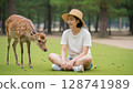 Female tourist and deer 128741989