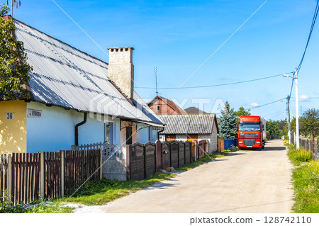 Brest Belarus colorful village streets with wooden huts brick houses . 128742110