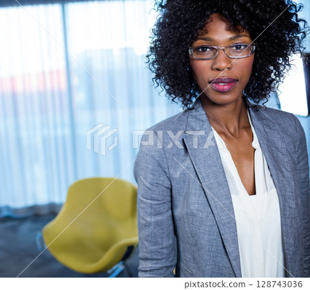 African American woman standing in office lounge by sheer curtains and yellow armchair, copy space African American woman standing in office lounge by sheer curtains and yellow armchair, copy space 128743036
