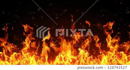 燃燒的火焰散開火花的背景材料。黑色背景上燃燒的真實火焰。火焰的充滿活力的運動和爆炸的火花 128743527