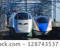 The silver Tsubasa train passes by the E7 Hokuriku Shinkansen and the E3 Yamagata Shinkansen. 128743537