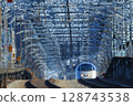 The silver Tsubasa E3 Yamagata Shinkansen suddenly appears as it departs Ueno Station 128743538