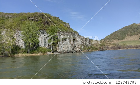 Majestic Mountain Landscape with River, Rocks, and Lush Greenery, Perfect for Outdoor Adventures Majestic Mountain Landscape with River, Rocks, and Lush Greenery, Perfect for Outdoor Adventures 128743795