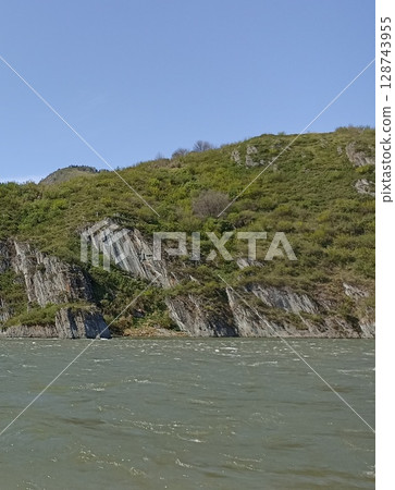 Majestic Mountain Landscape with River, Rocks, and Lush Greenery, Perfect for Outdoor Adventures Majestic Mountain Landscape with River, Rocks, and Lush Greenery, Perfect for Outdoor Adventures 128743955