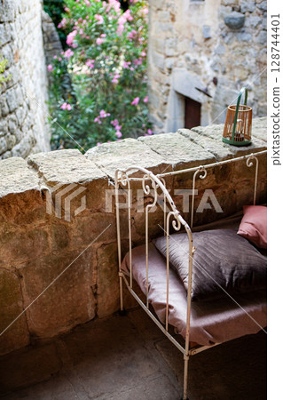 Vintage decoration in the patio of the stone house Vintage decoration in the patio of the stone house 128744401