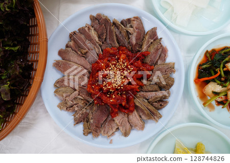 Korean Boiled Beef Slices with Spicy Pollock Salad and Sesame Seeds 128744826
